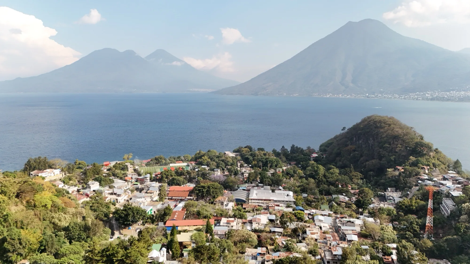 San Marcos La Laguna on the north shore of Lake Atitlán, with the San Pedro, Tolimán, and Atitlán volcanoes rising across the water